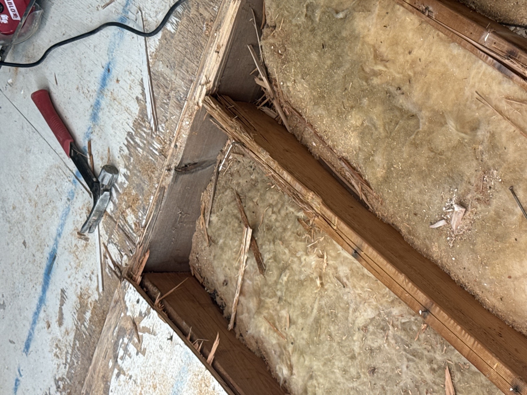 Room under renovation with exposed floor and tools