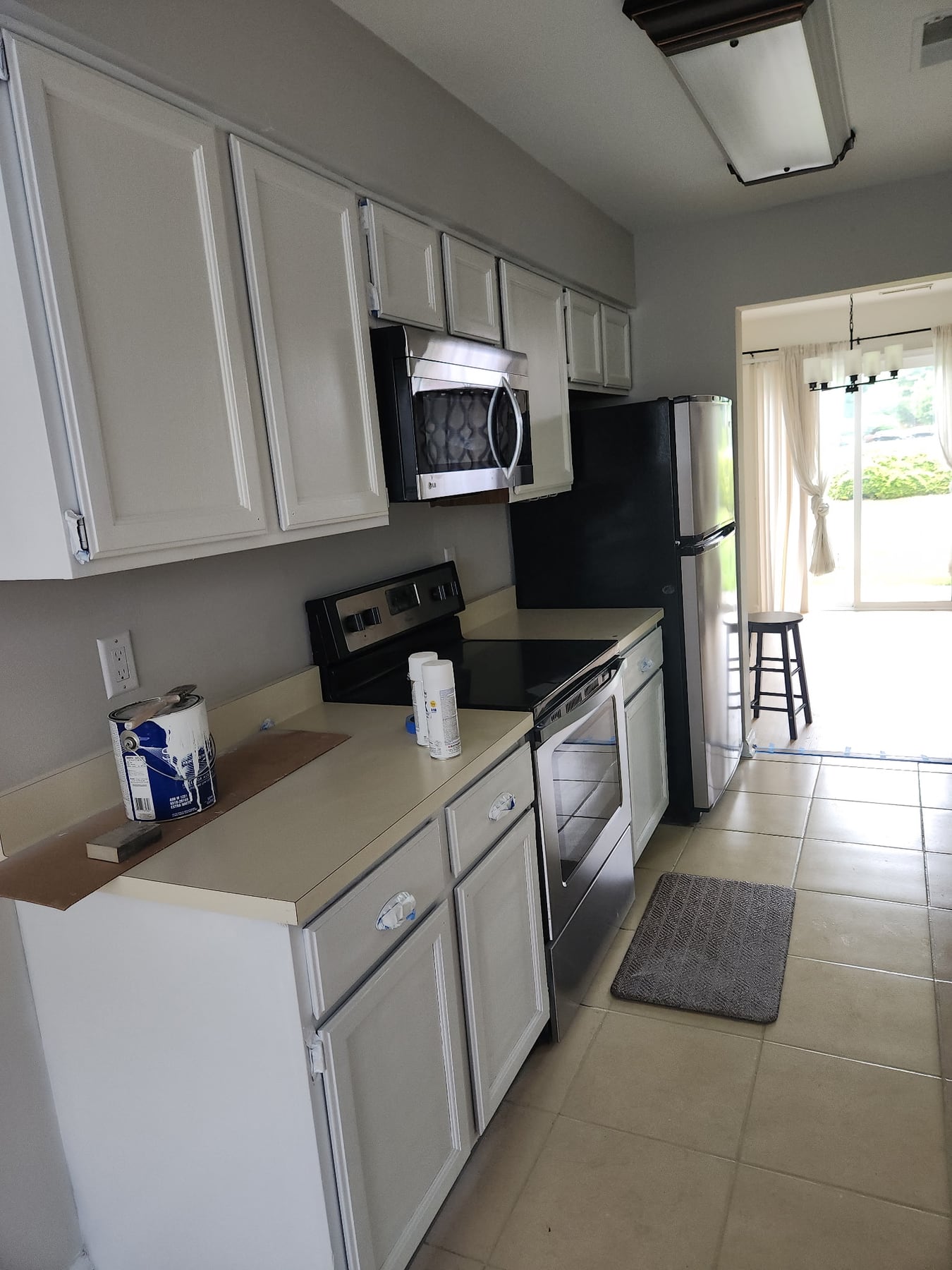 Kitchen with cabinets, stove, microwave, and refrigerator